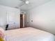 Bright bedroom featuring a full bed, a ceiling fan, and an open doorway leading to another room at 4338 Banjo Lake Rd, Land O Lakes, FL 34639