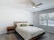 Cozy bedroom with a comfortable bed, nightstands, and a bright window at 4338 Banjo Lake Rd, Land O Lakes, FL 34639