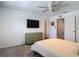Bright bedroom features a ceiling fan, dresser, and ensuite bath at 4338 Banjo Lake Rd, Land O Lakes, FL 34639