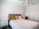 Comfortable bedroom with stylish decor, ceiling fan, a queen-size bed and bright natural light at 4338 Banjo Lake Rd, Land O Lakes, FL 34639