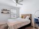 Cozy bedroom with a ceiling fan, bedside tables, and a comfortable bed with soft pillows at 4338 Banjo Lake Rd, Land O Lakes, FL 34639