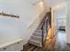 Welcoming entryway with a staircase, modern railings, and stylish wood-look flooring at 4338 Banjo Lake Rd, Land O Lakes, FL 34639
