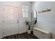 Bright entryway featuring a white door, decorative mirror, and a convenient storage bench at 4338 Banjo Lake Rd, Land O Lakes, FL 34639