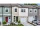 Modern townhome boasts a clean facade, attached garage, and well-maintained landscaping at 4338 Banjo Lake Rd, Land O Lakes, FL 34639