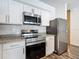 Bright kitchen features stainless appliances, granite countertops and white cabinets at 4338 Banjo Lake Rd, Land O Lakes, FL 34639