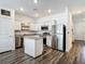 Bright kitchen features stainless appliances, granite countertops, white cabinets, island and wood floor at 4338 Banjo Lake Rd, Land O Lakes, FL 34639