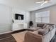 Cozy living room features a comfortable sectional sofa, modern TV, and stylish decor at 4338 Banjo Lake Rd, Land O Lakes, FL 34639