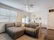 Bright living room flows into dining area, featuring a large sectional sofa at 4338 Banjo Lake Rd, Land O Lakes, FL 34639