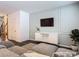Modern living room with paneled wall, TV, white console, and comfortable sectional sofa at 4338 Banjo Lake Rd, Land O Lakes, FL 34639