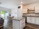 Bright living area with an open dining area, kitchen island, and hardwood floors at 4338 Banjo Lake Rd, Land O Lakes, FL 34639