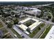 Aerial view of the apartment complex surrounded by mature trees, parking and nearby commercial areas at 5720 13Th N Ave # 207B, St Petersburg, FL 33710