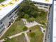 Aerial view of a landscaped courtyard with pathways, seating areas, and mature trees within the condo community at 5720 13Th N Ave # 207B, St Petersburg, FL 33710