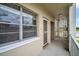 Condo balcony with concrete floor, decorative blocks, screen door and view of the outdoors at 5720 13Th N Ave # 207B, St Petersburg, FL 33710