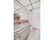 A retro bathroom featuring classic pink tiling, mosaic floors, and a vanity with ample storage at 5720 13Th N Ave # 207B, St Petersburg, FL 33710