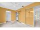 A bedroom featuring a ceiling fan, closet with sliding doors and adjoining room at 5720 13Th N Ave # 207B, St Petersburg, FL 33710