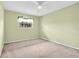 A cozy bedroom featuring neutral walls, carpet flooring, and a window with natural light at 5720 13Th N Ave # 207B, St Petersburg, FL 33710