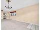 Empty living room features carpet, neutral walls, and chandelier lighting at 5720 13Th N Ave # 207B, St Petersburg, FL 33710