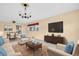 Living room boasts comfortable furniture, neutral colors, and natural light from the window at 5720 13Th N Ave # 207B, St Petersburg, FL 33710