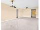 Empty living room featuring carpet, neutral paint and lighting overhead at 5720 13Th N Ave # 207B, St Petersburg, FL 33710