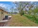 Expansive backyard featuring a well-maintained lawn, mature trees, and lush greenery at 5749 Southernview Dr, Zephyrhills, FL 33541
