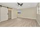 Bedroom featuring wood floors, recessed lighting, and a sliding barn door closet at 5749 Southernview Dr, Zephyrhills, FL 33541