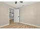 A bedroom doorway open to show the kitchen with white cabinets, microwave, oven, and countertops at 5749 Southernview Dr, Zephyrhills, FL 33541