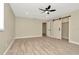 Spacious bedroom with wood floors and a white barn door leading to a closet at 5749 Southernview Dr, Zephyrhills, FL 33541