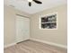 Bright bedroom with a ceiling fan, a window view, closet space, and luxury vinyl plank flooring at 5749 Southernview Dr, Zephyrhills, FL 33541