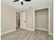 A bedroom with wood-look flooring, a ceiling fan, and a closet with the door open to see the interior at 5749 Southernview Dr, Zephyrhills, FL 33541