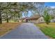 Charming single-story home with long driveway and mature trees on a large lot at 5749 Southernview Dr, Zephyrhills, FL 33541