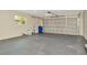 Spacious garage with gray painted floor, an automated garage door, and a window for natural light at 5749 Southernview Dr, Zephyrhills, FL 33541