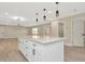 Open-concept kitchen with a large island, recessed lighting, and seamless flow into the adjacent living space at 5749 Southernview Dr, Zephyrhills, FL 33541
