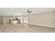 Open-concept living space featuring a kitchen island, neutral walls, and wood-look flooring at 5749 Southernview Dr, Zephyrhills, FL 33541