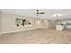 Bright living space with neutral walls, wood floors, and a large window showcasing the outdoor view at 5749 Southernview Dr, Zephyrhills, FL 33541