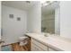 Neutral bathroom with a long vanity, framed mirror, a walk-in shower with glass doors, and nautical decor at 630 Kirkland Cir, Dunedin, FL 34698