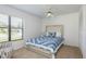 Bright bedroom with a ceiling fan, window with blinds, and a comfortable bed with blue bedding at 630 Kirkland Cir, Dunedin, FL 34698