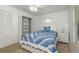 Bedroom featuring a ceiling fan, window with blinds, and a closet with shelving at 630 Kirkland Cir, Dunedin, FL 34698