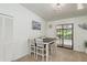 Cozy dining area with seating for four and a sliding glass door to the pool at 630 Kirkland Cir, Dunedin, FL 34698