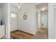 Inviting entryway with wood-look floors, coat closet, and attractive mirror accent at 630 Kirkland Cir, Dunedin, FL 34698