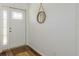 Bright entryway featuring wood flooring, a stylish mirror, and a well-lit, welcoming space at 630 Kirkland Cir, Dunedin, FL 34698