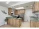 Bright kitchen featuring stainless steel appliances, unique wood cabinetry, and ample countertop space at 630 Kirkland Cir, Dunedin, FL 34698