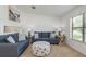 Comfortable living room with neutral carpet, cozy seating, and a bright, airy feel at 630 Kirkland Cir, Dunedin, FL 34698