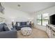 Cozy living room with comfortable seating, neutral carpet, and ample natural light at 630 Kirkland Cir, Dunedin, FL 34698
