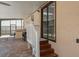 Outdoor patio featuring brick pavers, outdoor kitchen, grill, and stairs leading into the home at 630 Kirkland Cir, Dunedin, FL 34698