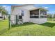 Spacious backyard with an enclosed porch, offering a tranquil outdoor space with a fenced perimeter at 6603 S Juanita St, Tampa, FL 33616