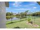 View of the backyard with a pond view under bright skies at 6603 S Juanita St, Tampa, FL 33616