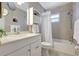 Clean bathroom featuring shower-tub combo and bright vanity at 6603 S Juanita St, Tampa, FL 33616