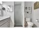 Bright bathroom featuring modern gray vanity with a framed, frosted glass shower at 6603 S Juanita St, Tampa, FL 33616