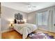 Comfortable bedroom with wood floors, neutral decor, and natural light from the window at 6603 S Juanita St, Tampa, FL 33616