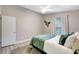Cozy bedroom featuring wood floors, a plush rug, and a ceiling fan for added comfort at 6603 S Juanita St, Tampa, FL 33616